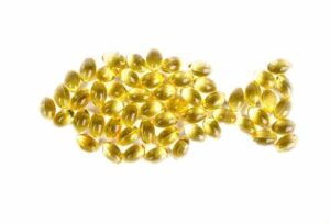Omega 3 capsules in the shape of a fish.