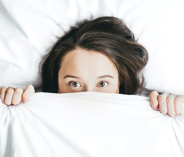 Is L-Theanine Good for Social Anxiety - Woman Hiding Under Bed Sheet