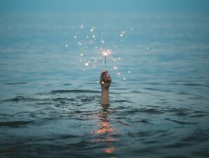 Is L-Theanine Good for Social Anxiety? - Hand Holding Sparkler above Water