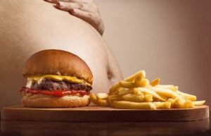 Best Supplement for Energy and Concentration - Burger and Fries in Front of Fat Tummy